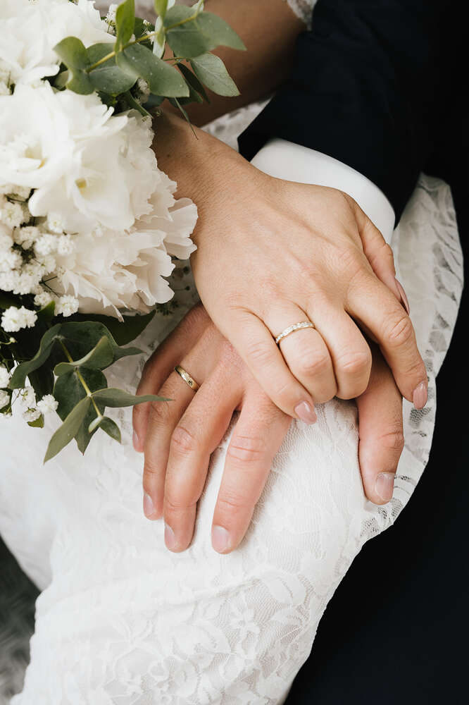 Hände eines Brautpaaren mit frisch angelegeten Eheringen (Jennifer Hartmann | Photography & Artist)